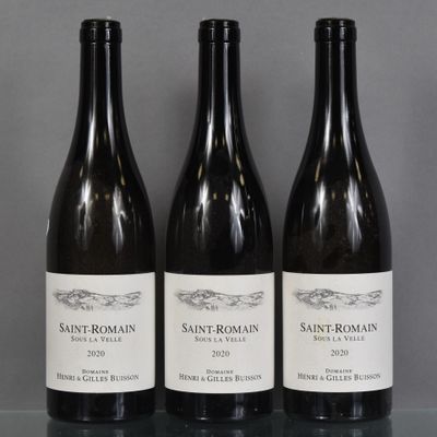 three bottles of wine sit on a table in front of a gray background