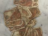 a pile of old money sitting on a marble table