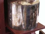 a silver pot sitting on top of a wooden cabinet