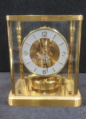 a gold clock that is sitting on a table