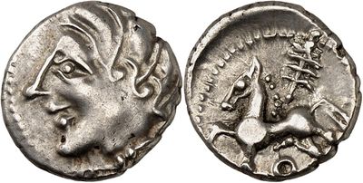 a silver coin with an image of a woman and a bird on it