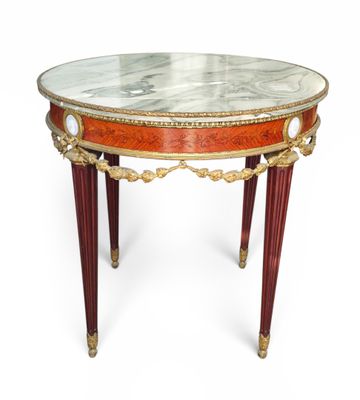 a small table with a marble top and red legs