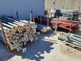 a lot of pipes that are stacked up on the ground