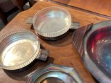 a wooden table topped with metal dishes and pans