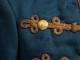 a close up of a military uniform with gold buttons