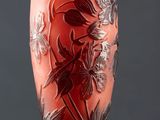 an image of a red vase with flowers on it