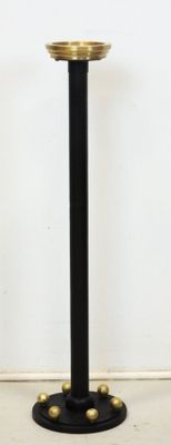 black and gold pedestal with a gold plate on top