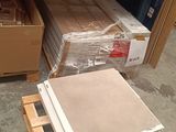 a pile of books on a pallet next to a pile of boxes