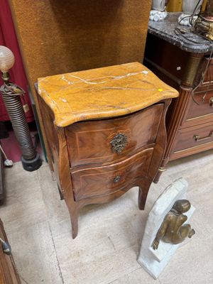 a wooden table with a marble top in a room