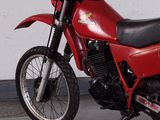 a red motorcycle that is parked in a garage