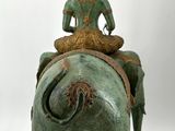 statue of an elephant with a person sitting on it ' s back