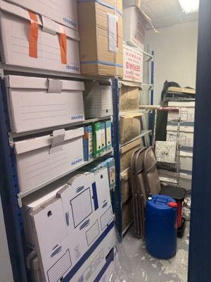 une pièce avec beaucoup de boîtes et de cartons sur les étagères