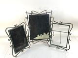 three black and white picture frames sitting next to each other on a white surface