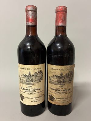 two bottles of red wine sitting next to each other on a table