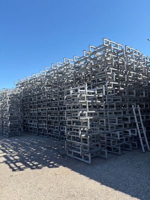 a large pile of metal crates stacked on top of each other