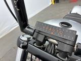 a close up of a motorcycle with a measuring scale on the handlebar
