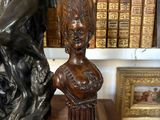 a bronze statue of a woman holding a child