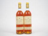 deux bouteilles de whisky posées l'une à côté de l'autre sur une surface blanche