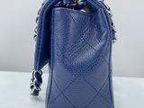 a small blue purse with a chain hanging from it