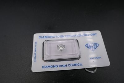 a close up of a diamond on a card on a table