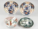 three japanese bowls and a bowl with a design of flowers and birds