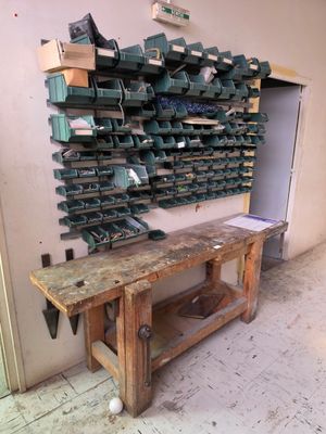 a wooden workbench with a bunch of tools on it