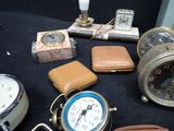 many different types of clocks on a black table