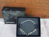 a black box with a silver bracelet and a black box with a silver bracelet