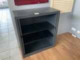 a metal cabinet with shelves in the corner of a room