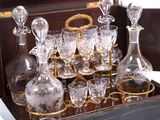 bottles and glasses on a tray on a table with a white table cloth