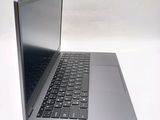 a silver laptop with a black keyboard on a white surface