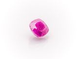 a close up of a pink diamond on a white surface