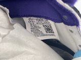 purple and white jacket with a tag on it and a pair of scissors in the pocket
