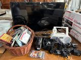 a basket full of electronics on a table next to a television