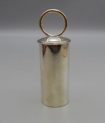a silver metal container with a gold ring on top of it