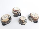 four different types of coffee mugs sitting on top of a white surface