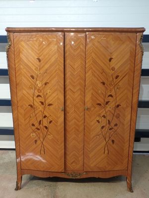 an image of a wooden cabinet with a floral design on it