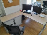 a desk with two monitors and a keyboard on it