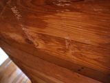 a close up of a wooden table with a window in the background