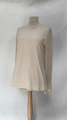 beige long sleeved top on a mannequin base