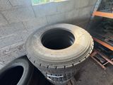 a pile of tires sitting next to a pile of pallets