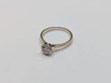 a close up of a diamond ring on a white surface