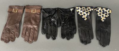 four pairs of leather gloves with gold buckles on them
