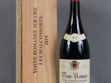 a bottle of wine sitting next to a wooden box