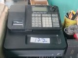 a black cash register sitting on top of a desk