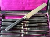 a small knife in a case with a lot of tools inside of it