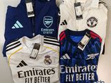a group of three soccer shirts sitting on top of a table