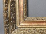 an antique gold frame with a decorative pattern on the edges
