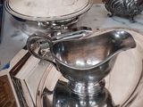 a silver plate with a silver gravy on it and a silver plate with a silver gravy on it