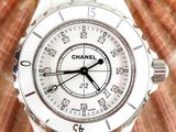 a white watch with a black second hand on a shell